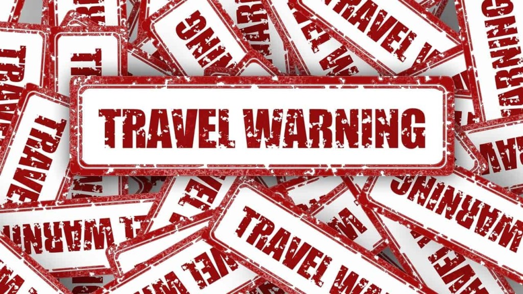 Travel warning advisory notice: By Gerd Altmann via Pixabay. https://pixabay.com/illustrations/travel-warning-shield-stamp-2521727/