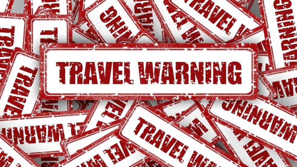 Travel warning advisory notice: By Gerd Altmann via Pixabay. https://pixabay.com/illustrations/travel-warning-shield-stamp-2521727/