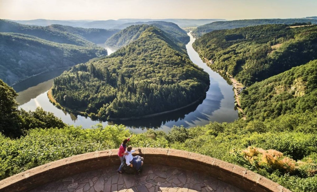 Couple at an accessible viewpoint overlooking Saarschleife (Saar Loop) in the German region of "Saarland", which is certifiably sustainable. Image by Jens Wegener; supplied by GNTB.