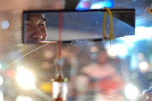 Smiling eyes of a Bangkok taxi driver. Image by David Gillbanks