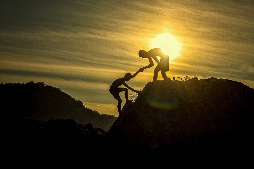 A common challenge. Image by sasint (CC0) via Pixabay. https://pixabay.com/photos/sunset-men-silhouettes-helping-1807524/