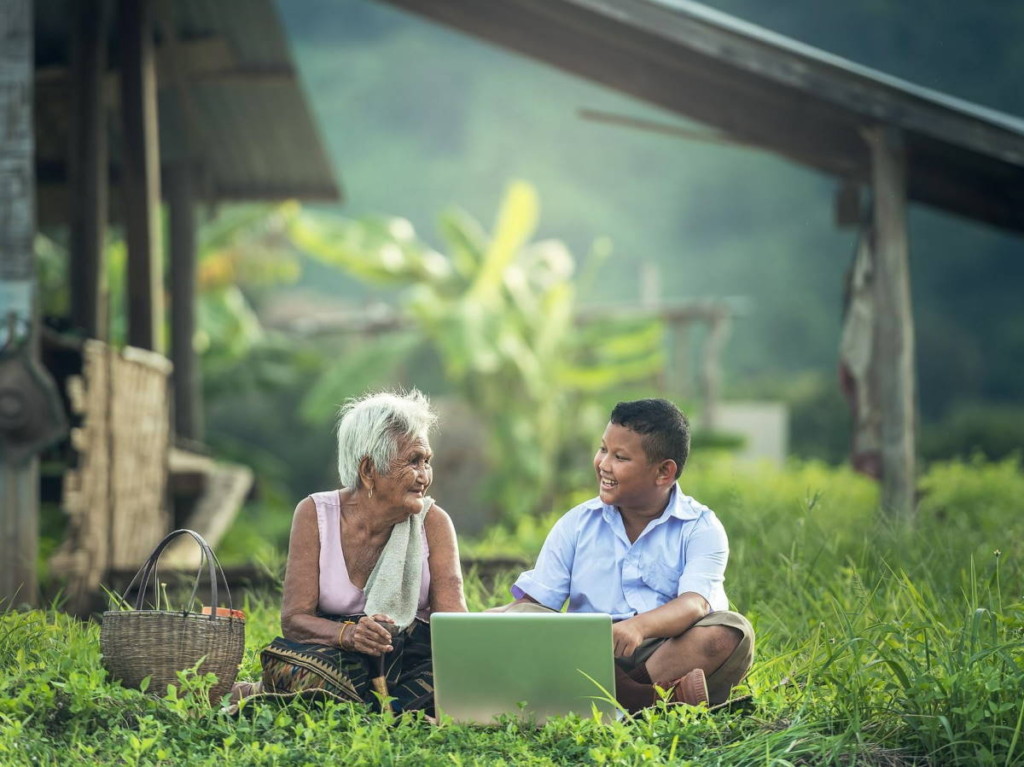 Degrowth is about relationships that matter. Image by Sasin Tipchai (CC0) via Pixabay. https://pixabay.com/photos/grandmother-kids-laptop-myanmar-1822560/