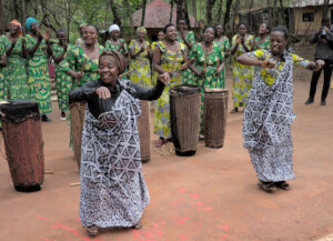 Dancers, singers, and drummers from a local women’s cooperative welcome visitors to the Red Rocks Cultural Center in Nyakinama village, Rwanda. Pic by David Gillbanks.